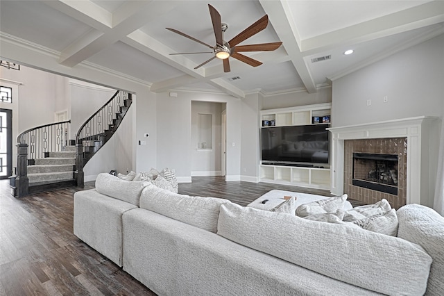 living room featuring coffered ceiling, crown molding, dark hardwood / wood-style floors, beamed ceiling, and a fireplace