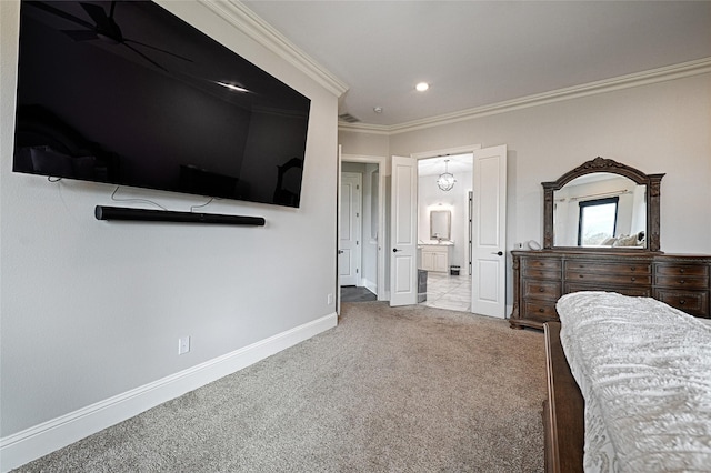 bedroom featuring crown molding, light colored carpet, and connected bathroom