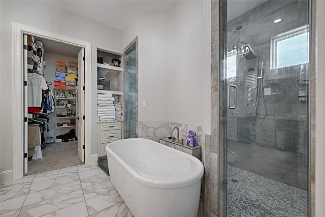 bathroom featuring shower with separate bathtub