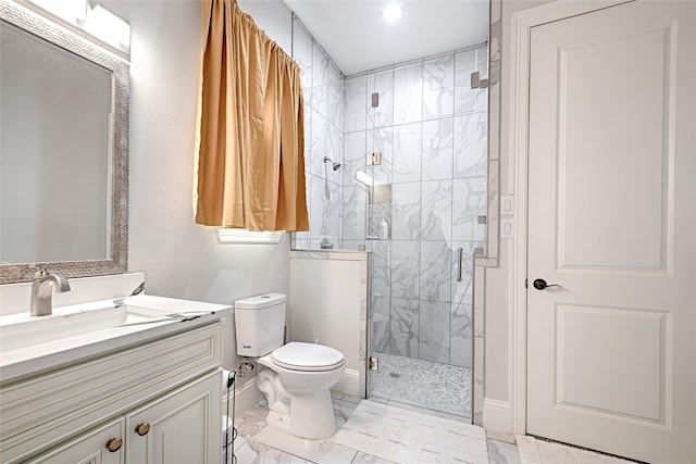 bathroom featuring vanity, toilet, and a shower with door