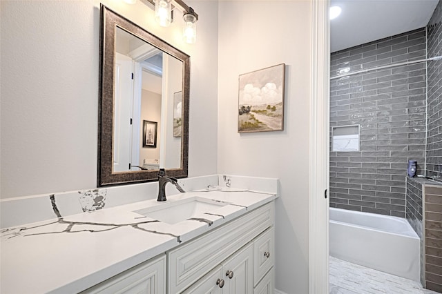 bathroom with vanity and tiled shower / bath combo