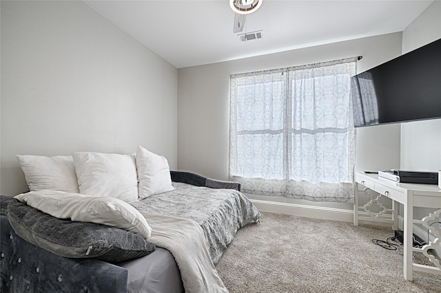 bedroom featuring vaulted ceiling and carpet