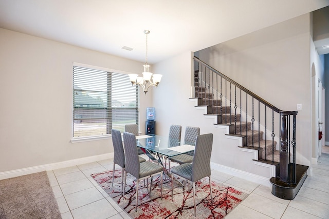 dining room featuring a wealth of natural light, light tile patterned flooring, and a chandelier