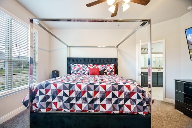 carpeted bedroom featuring connected bathroom and ceiling fan