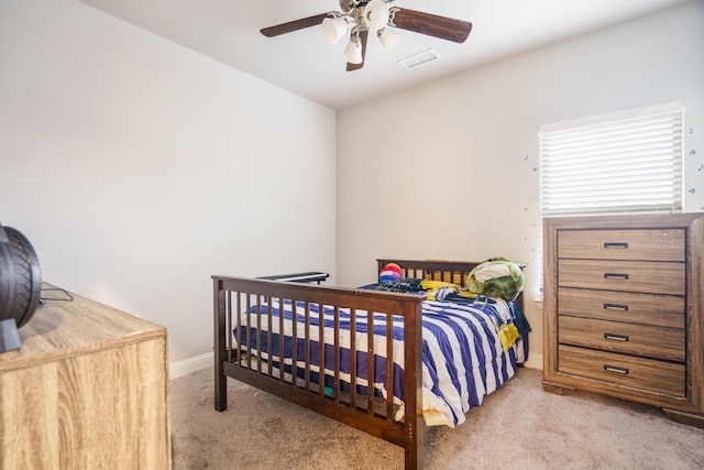 bedroom with ceiling fan and light colored carpet