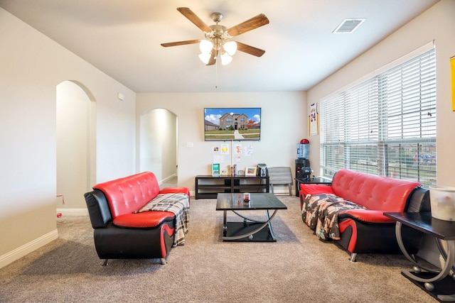 carpeted living room featuring ceiling fan