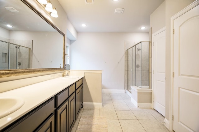 bathroom featuring tile patterned flooring, vanity, and walk in shower