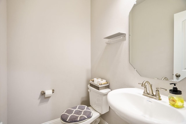 bathroom featuring toilet and sink