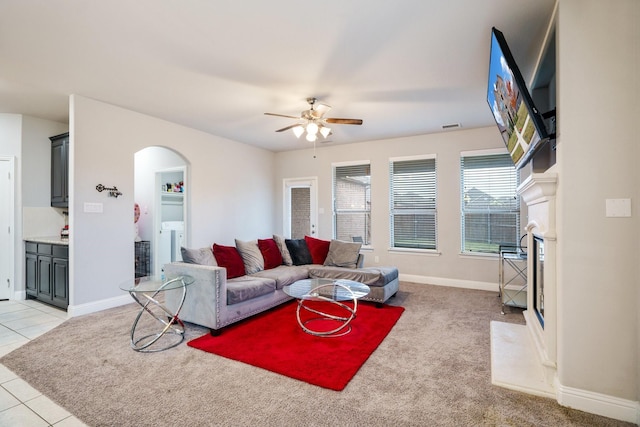 living room with ceiling fan, washing machine and dryer, and light colored carpet