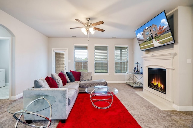 carpeted living room featuring washer / clothes dryer and ceiling fan