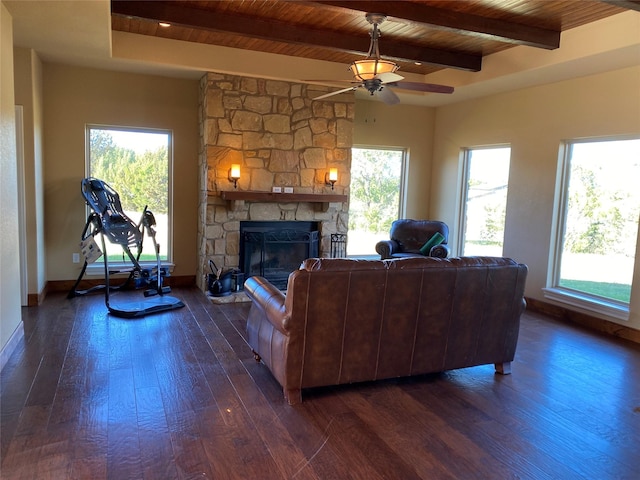 living room with wood ceiling, ceiling fan, beam ceiling, dark hardwood / wood-style floors, and a stone fireplace