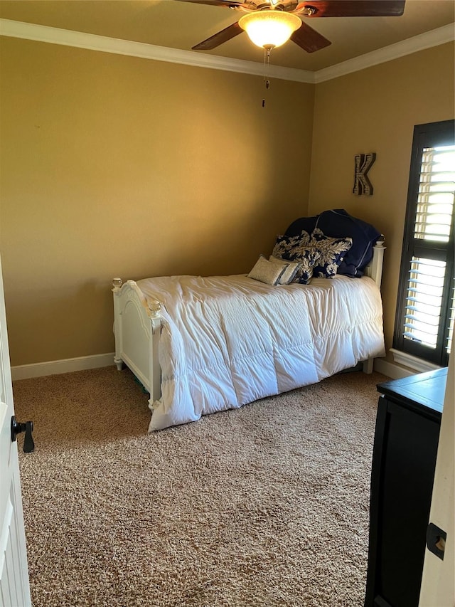 carpeted bedroom with ornamental molding and ceiling fan