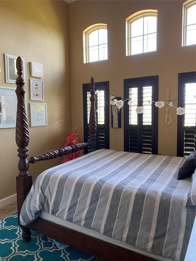 bedroom featuring multiple windows and carpet