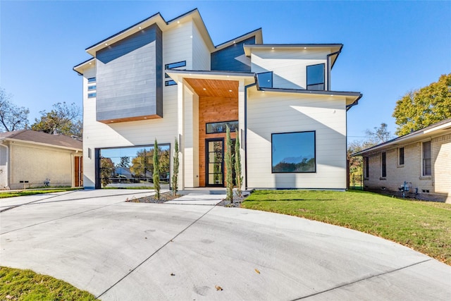 modern home with a front lawn