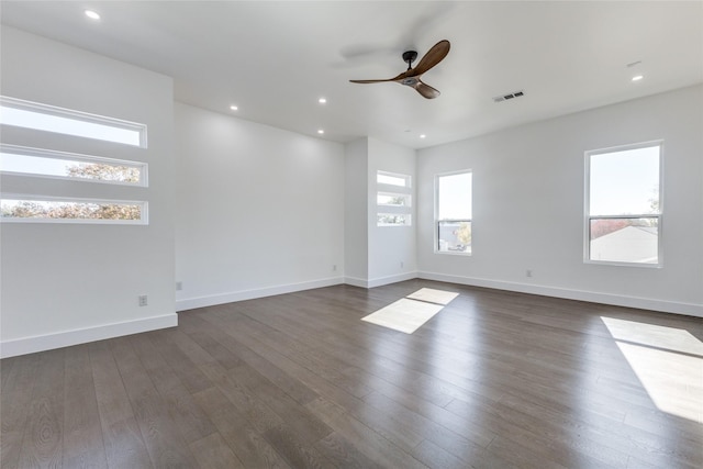 spare room featuring ceiling fan and dark hardwood / wood-style flooring