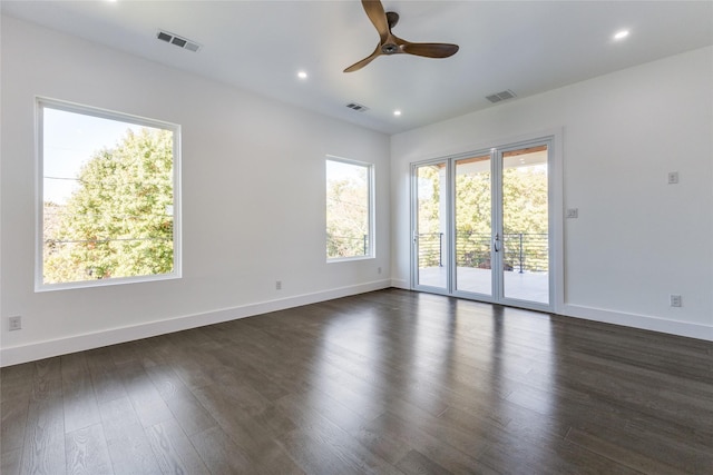 empty room featuring dark wood-type flooring and ceiling fan