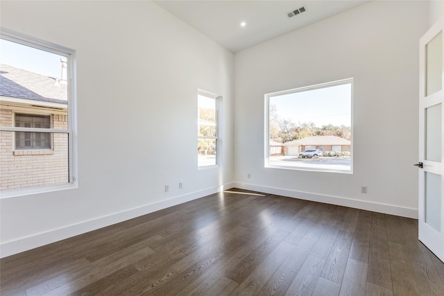 unfurnished room with dark hardwood / wood-style floors