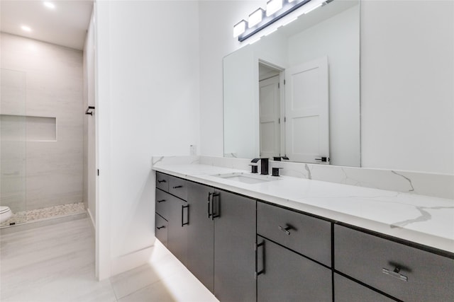 bathroom featuring vanity and tiled shower