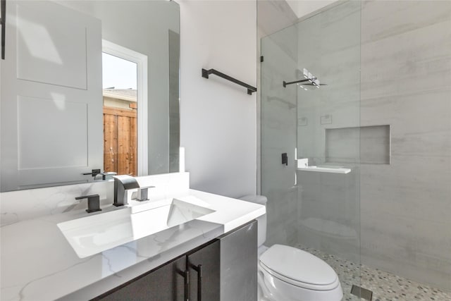 bathroom with decorative backsplash, toilet, walk in shower, and vanity