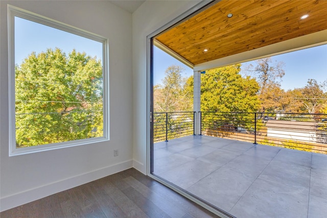 doorway featuring wooden ceiling and dark hardwood / wood-style floors