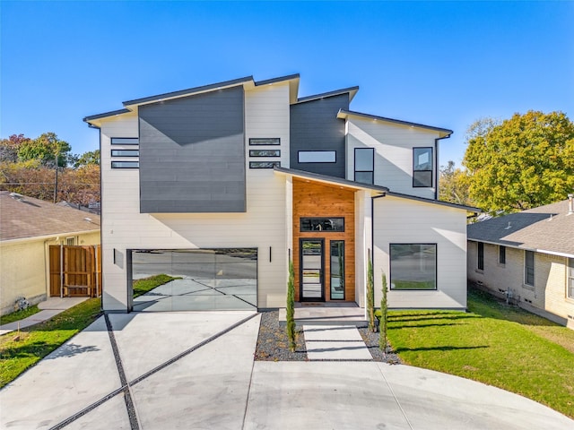 modern home with a garage and a front yard