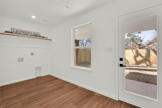 washroom with washer hookup, a healthy amount of sunlight, hookup for an electric dryer, and wood-type flooring