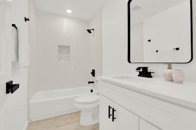 full bathroom featuring vanity, toilet, wood-type flooring, and shower / bathing tub combination