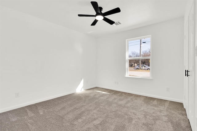 carpeted spare room with ceiling fan