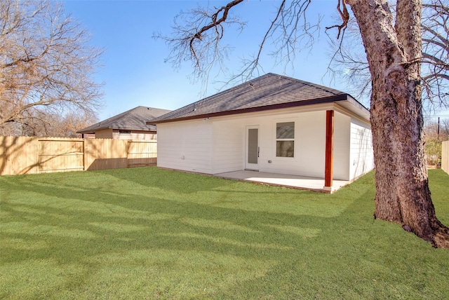 rear view of property with a patio area and a yard