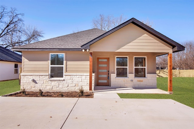 view of front of property with a patio area and a front lawn