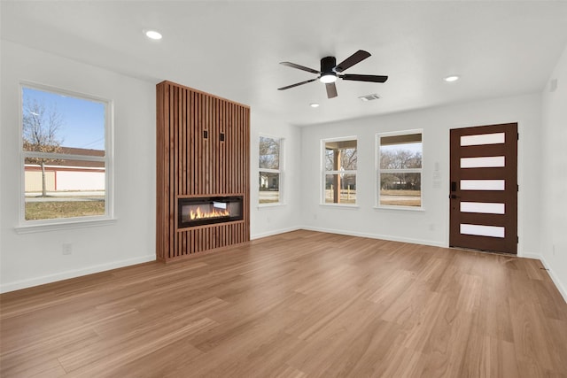 unfurnished living room featuring light hardwood / wood-style floors and ceiling fan