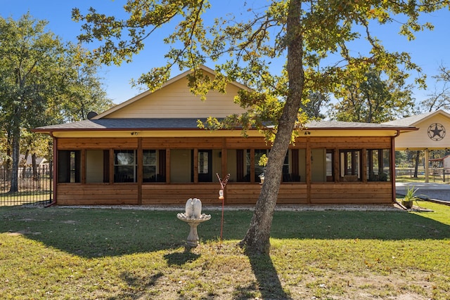 rear view of house featuring a lawn