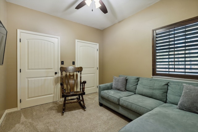 living room featuring ceiling fan and light colored carpet