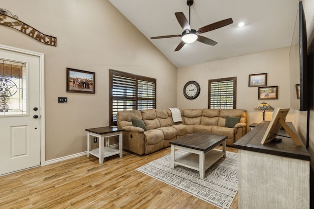 living room with ceiling fan, high vaulted ceiling, and light wood-type flooring