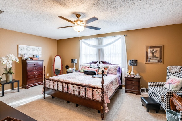 bedroom with carpet floors, visible vents, and a textured ceiling