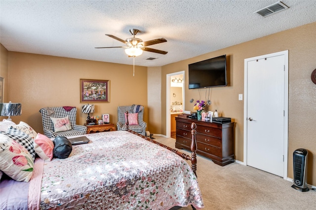 bedroom featuring a textured ceiling, a ceiling fan, visible vents, and light colored carpet