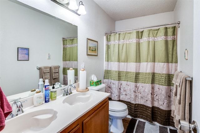 bathroom featuring shower / tub combo, a sink, a textured ceiling, and double vanity