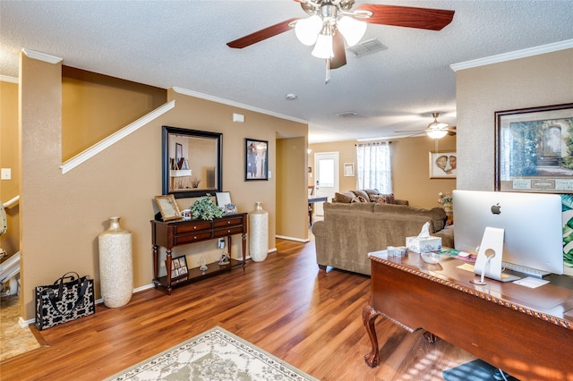 home office featuring visible vents, crown molding, a textured ceiling, and wood finished floors