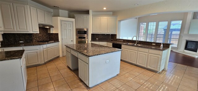 kitchen featuring white cabinets, a kitchen island, and stainless steel appliances