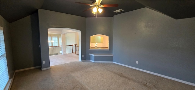 spare room with carpet, ceiling fan, and lofted ceiling