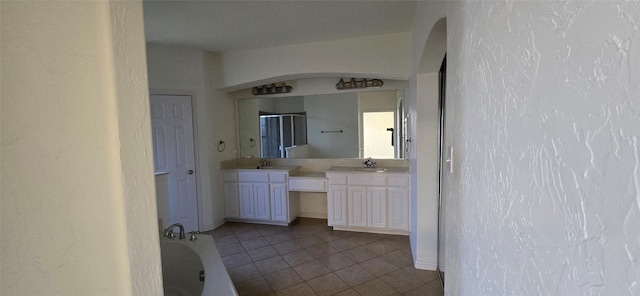 bathroom featuring vanity, tile patterned floors, and a bathing tub