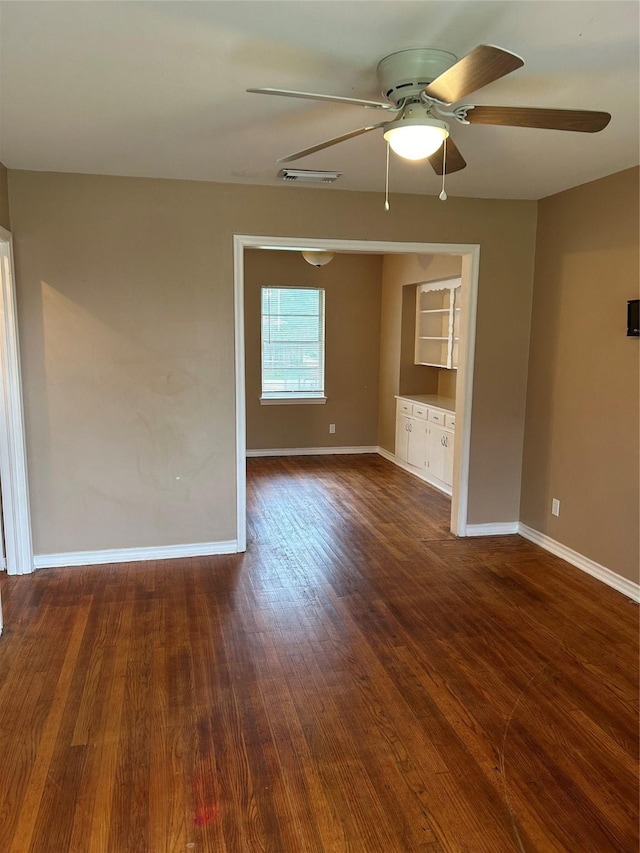 spare room with ceiling fan and dark hardwood / wood-style flooring