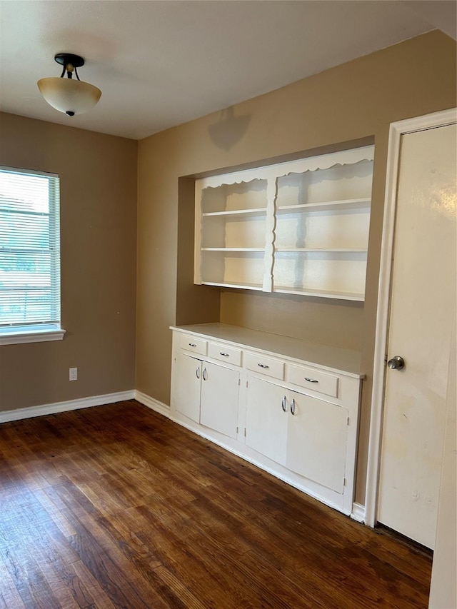 unfurnished dining area with dark hardwood / wood-style flooring