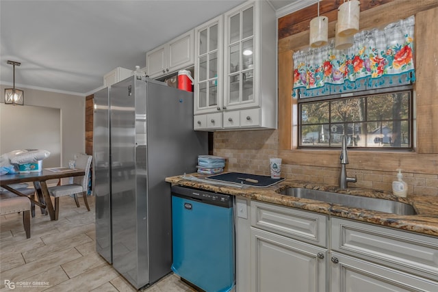 kitchen featuring sink, white cabinetry, stainless steel fridge, dishwasher, and decorative backsplash