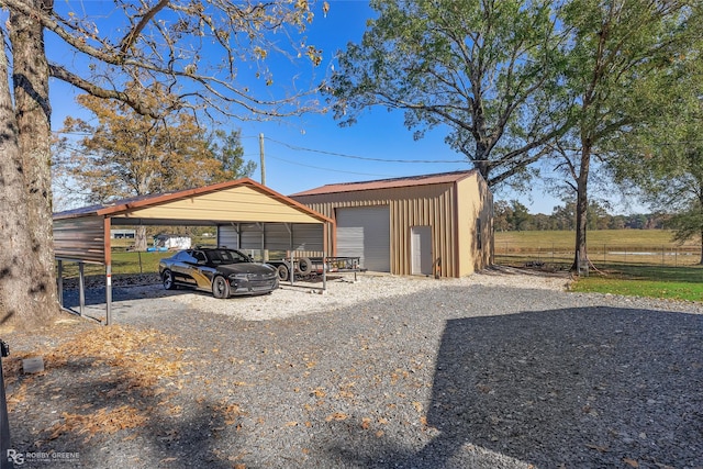 view of outbuilding with a carport and a garage