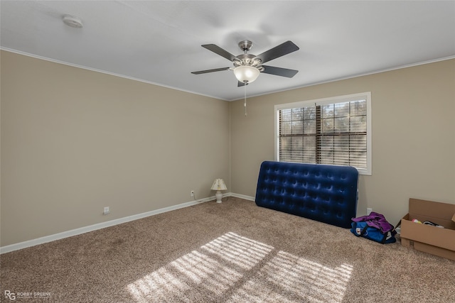 interior space featuring crown molding, carpet, and ceiling fan