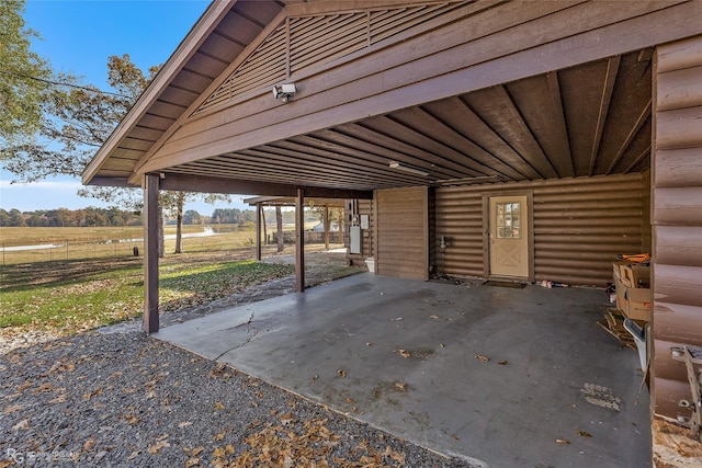 view of patio / terrace featuring a carport and a rural view