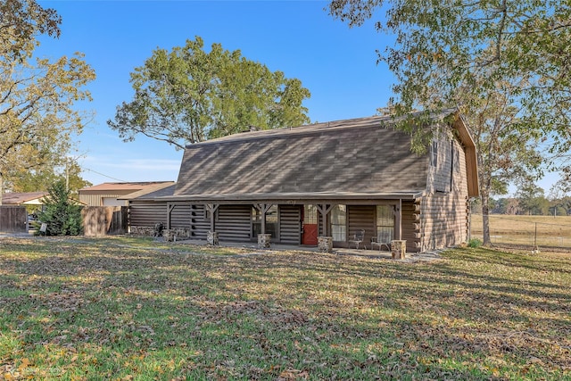 rear view of property with a lawn