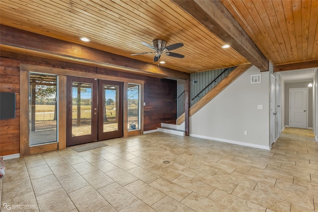 interior space featuring beamed ceiling, wooden ceiling, wooden walls, and french doors