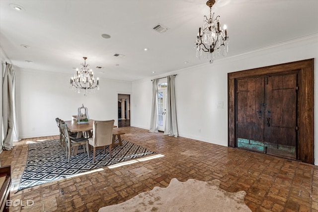 dining area with an inviting chandelier and crown molding